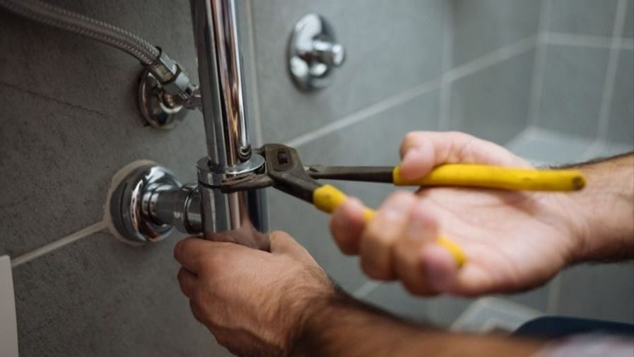 Working on repairing a bathroom plumbing pipe