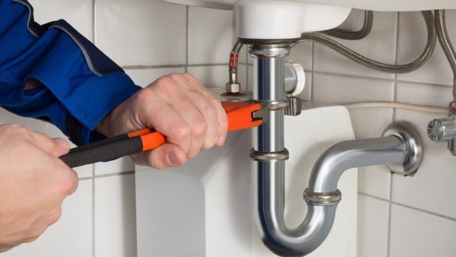 Working on piping in a bathroom